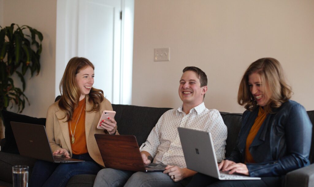 Golden Tongue Team Laughing On Couch Positive Company Culture